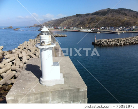 Aerial view of the white lighthouse at Toyohama fishing port in Otobe-cho, Hokkaido in early spring Aerial view of the white lighthouse at Toyohama fishing port in Otobe-cho, Hokkaido in early spring 76081973