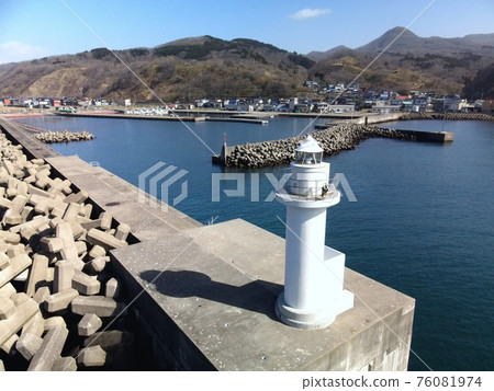 Aerial view of the white lighthouse at Toyohama fishing port in Otobe-cho, Hokkaido in early spring Aerial view of the white lighthouse at Toyohama fishing port in Otobe-cho, Hokkaido in early spring 76081974