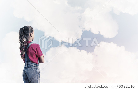 Concept of careless happy childhood with girl looking in future Concept of careless happy childhood with girl looking in future 76082116