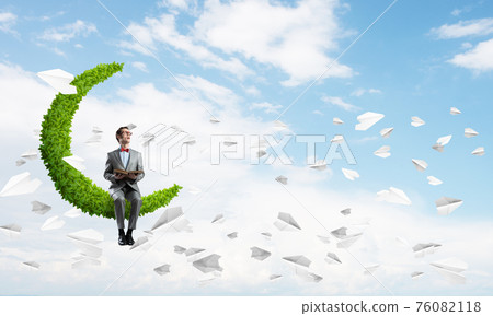 Young businessman or student studying the science and paper planes fly around Young businessman or student studying the science and paper planes fly around 76082118