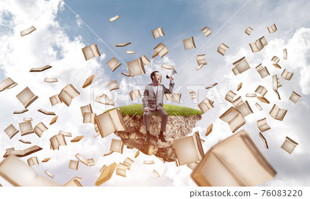 Businessman announcing something in loudspeaker and books fly around Businessman announcing something in loudspeaker and books fly around 76083220