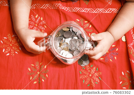 child girl pile coin for saving on bed , top view child girl pile coin for saving on bed , top view 76083302