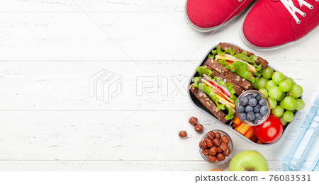 Healthy school lunch box with sandwich and fresh vegetables 76083531