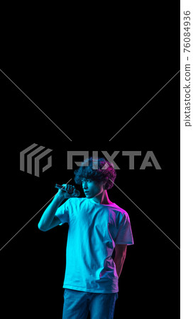 POrtrait of young Caucasian man singing isolated over dark background in neon POrtrait of young Caucasian man singing isolated over dark background in neon 76084936