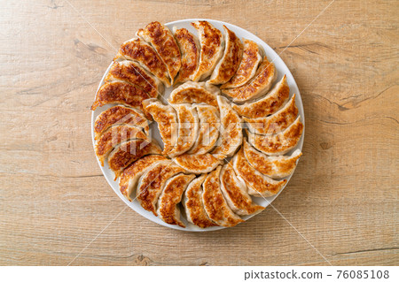 fried gyoza or dumplings snack with soy sauce 76085108