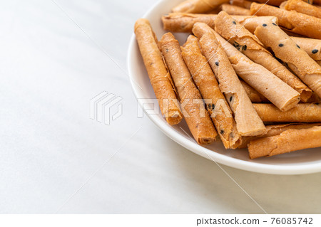 crispy coconut roll on plate crispy coconut roll on plate 76085742