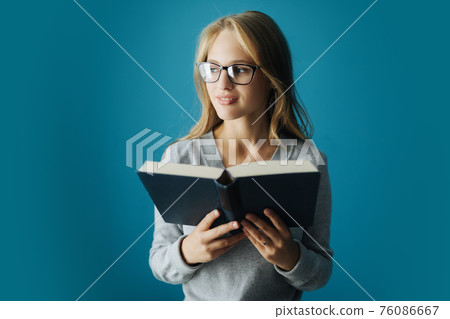 Woman reading book at home Woman reading book at home 76086667