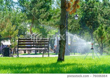 city park on a summer day, green lawns with grass and trees, paths and benches, people walking and children playing, bright sunlight and shadows city park on a summer day, green lawns with grass and trees, paths and benches, people walking and children playing, bright sunlight and shadows 76086864