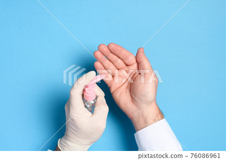 hand sanitizer treatment, health care prevention of coronavirus infection, hands hands in medical gloves on a blue background hand sanitizer treatment, health care prevention of coronavirus infection, hands hands in medical gloves on a blue background 76086961