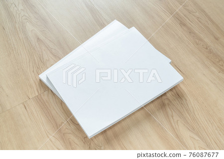 Book cover mockup with blank white front paper page a4 paperback mock up for catalog, magazine, menu, booklet, notebook, portfolio design template on wood table background 76087677