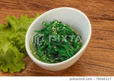 Green Chuka Seaweed Salad Isolated on White Background Top View. Wakame Sea Kelp Salat Green Chuka Seaweed Salad Isolated on White Background Top View. Wakame Sea Kelp Salat 76088127