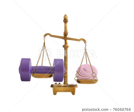 dumbbell with marshmallow on scale - comparison calories 76088768