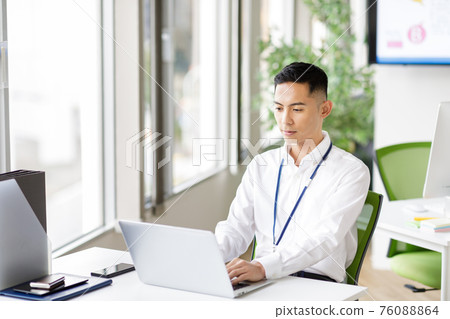 一個男人在筆記本電腦上工作 一個男人在筆記本電腦上工作 76088864