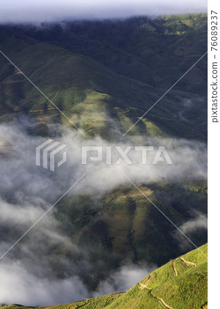 Ta Xua is a famous mountain range in northern Vietnam. All year round, the mountain rises above the clouds creating cloud inversions. Ta Xua is a famous mountain range in northern Vietnam. All year round, the mountain rises above the clouds creating cloud inversions. 76089237