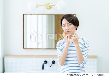 Woman suffering from mask trouble Woman suffering from mask trouble 76090060