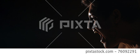 Caucasian man with a bared torso shouts on a dark background, banner, in a dark key, close-up Caucasian man with a bared torso shouts on a dark background, banner, in a dark key, close-up 76092291