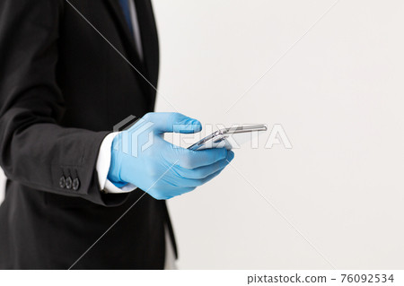 Smartphone rubber gloves businessman hand Smartphone rubber gloves businessman hand 76092534