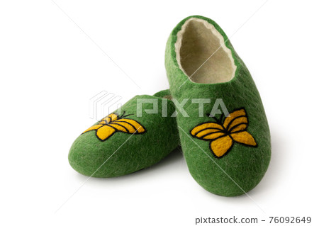 Felt slippers on white background in closeup Felt slippers on white background in closeup 76092649