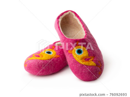 Felt slippers on white background in closeup Felt slippers on white background in closeup 76092693