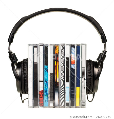 Headphones on stack of CDs 76092750