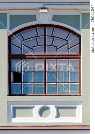 Window on a gray wall. 76092844