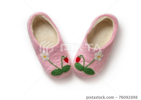 Felt slippers on white background in closeup 76092898