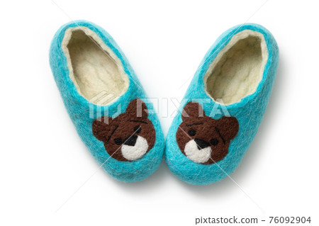 Felt slippers on white background in closeup Felt slippers on white background in closeup 76092904