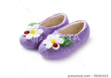 Felt slippers on white background in closeup Felt slippers on white background in closeup 76092923