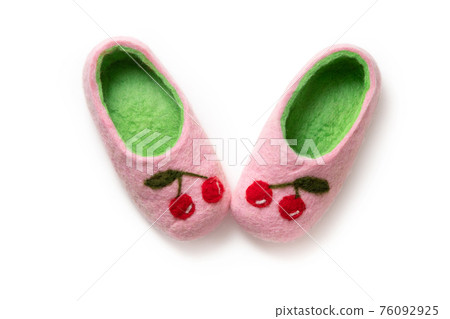 Felt slippers on white background in closeup Felt slippers on white background in closeup 76092925