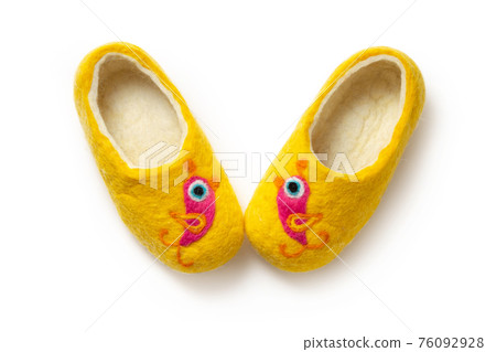 Felt slippers on white background in closeup Felt slippers on white background in closeup 76092928