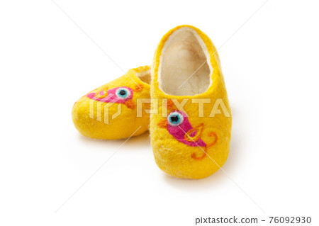 Felt slippers on white background in closeup Felt slippers on white background in closeup 76092930