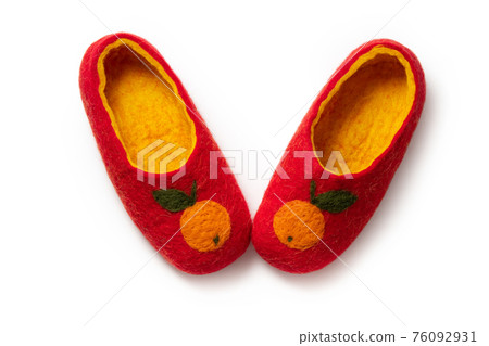 Felt slippers on white background in closeup 76092931