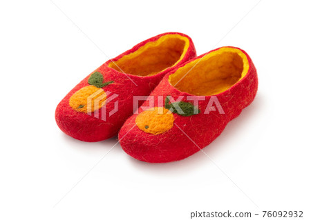 Felt slippers on white background in closeup 76092932