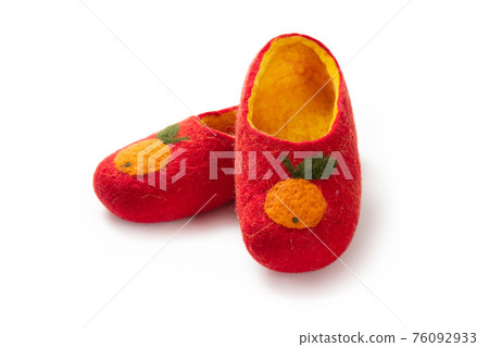 Felt slippers on white background in closeup Felt slippers on white background in closeup 76092933