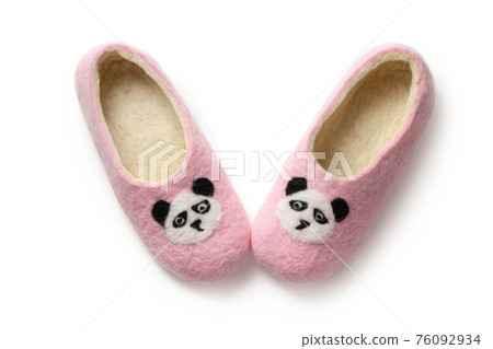 Felt slippers on white background in closeup 76092934