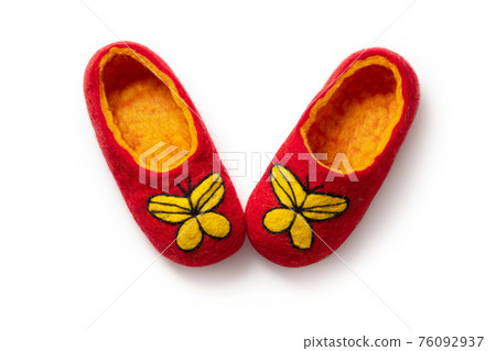 Felt slippers on white background in closeup Felt slippers on white background in closeup 76092937