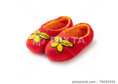 Felt slippers on white background in closeup Felt slippers on white background in closeup 76092938