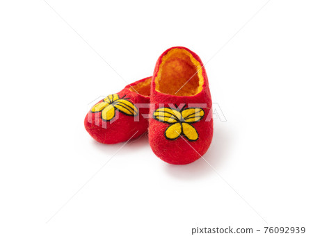 Felt slippers on white background in closeup Felt slippers on white background in closeup 76092939
