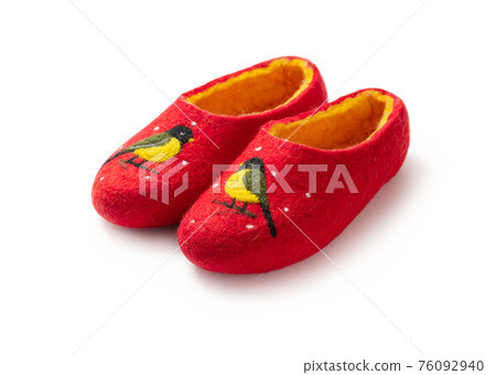Felt slippers on white background in closeup Felt slippers on white background in closeup 76092940