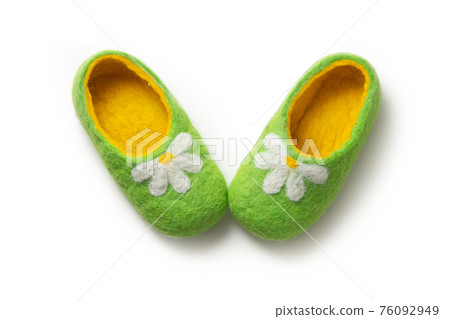 Felt slippers on white background in closeup Felt slippers on white background in closeup 76092949