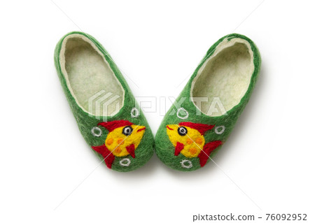 Felt slippers on white background in closeup Felt slippers on white background in closeup 76092952