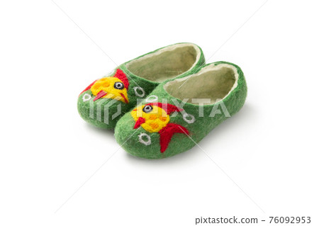Felt slippers on white background in closeup 76092953