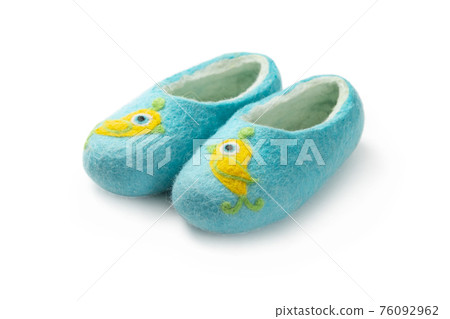 Felt slippers on white background in closeup Felt slippers on white background in closeup 76092962