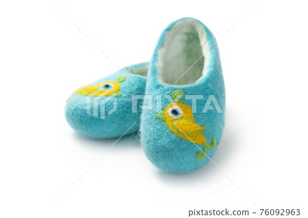 Felt slippers on white background in closeup Felt slippers on white background in closeup 76092963