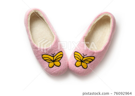 Felt slippers on white background in closeup Felt slippers on white background in closeup 76092964