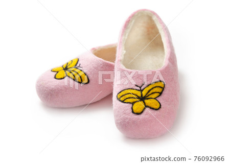Felt slippers on white background in closeup Felt slippers on white background in closeup 76092966