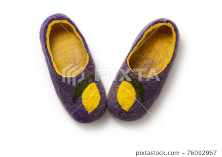 Felt slippers on white background in closeup 76092967