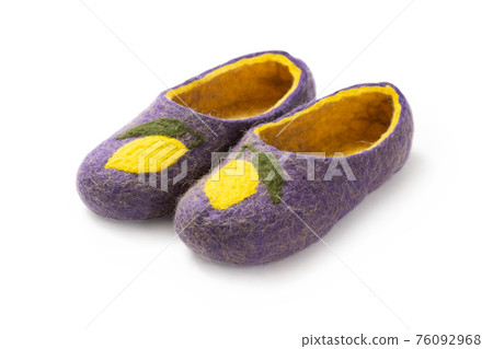 Felt slippers on white background in closeup Felt slippers on white background in closeup 76092968
