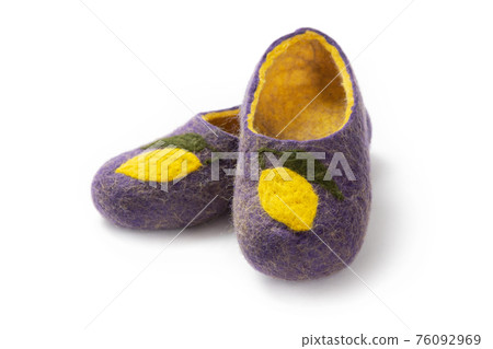 Felt slippers on white background in closeup Felt slippers on white background in closeup 76092969