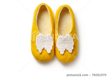 Felt slippers on white background in closeup Felt slippers on white background in closeup 76092970